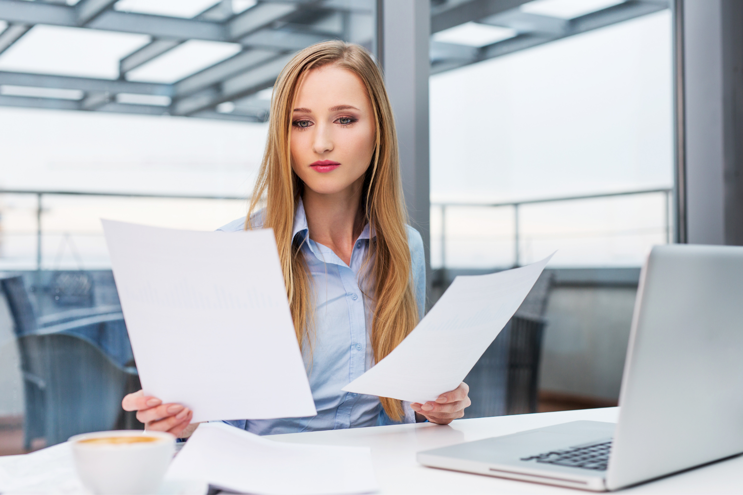 Business owner comparing broker fee proposals.