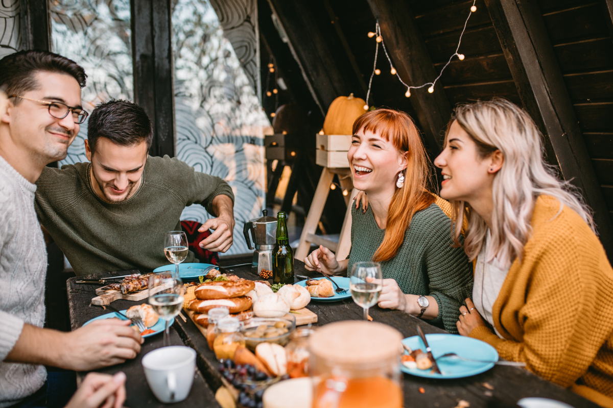 Friends exchanging thoughtful Thanksgiving wishes, creating a joyous holiday atmosphere.