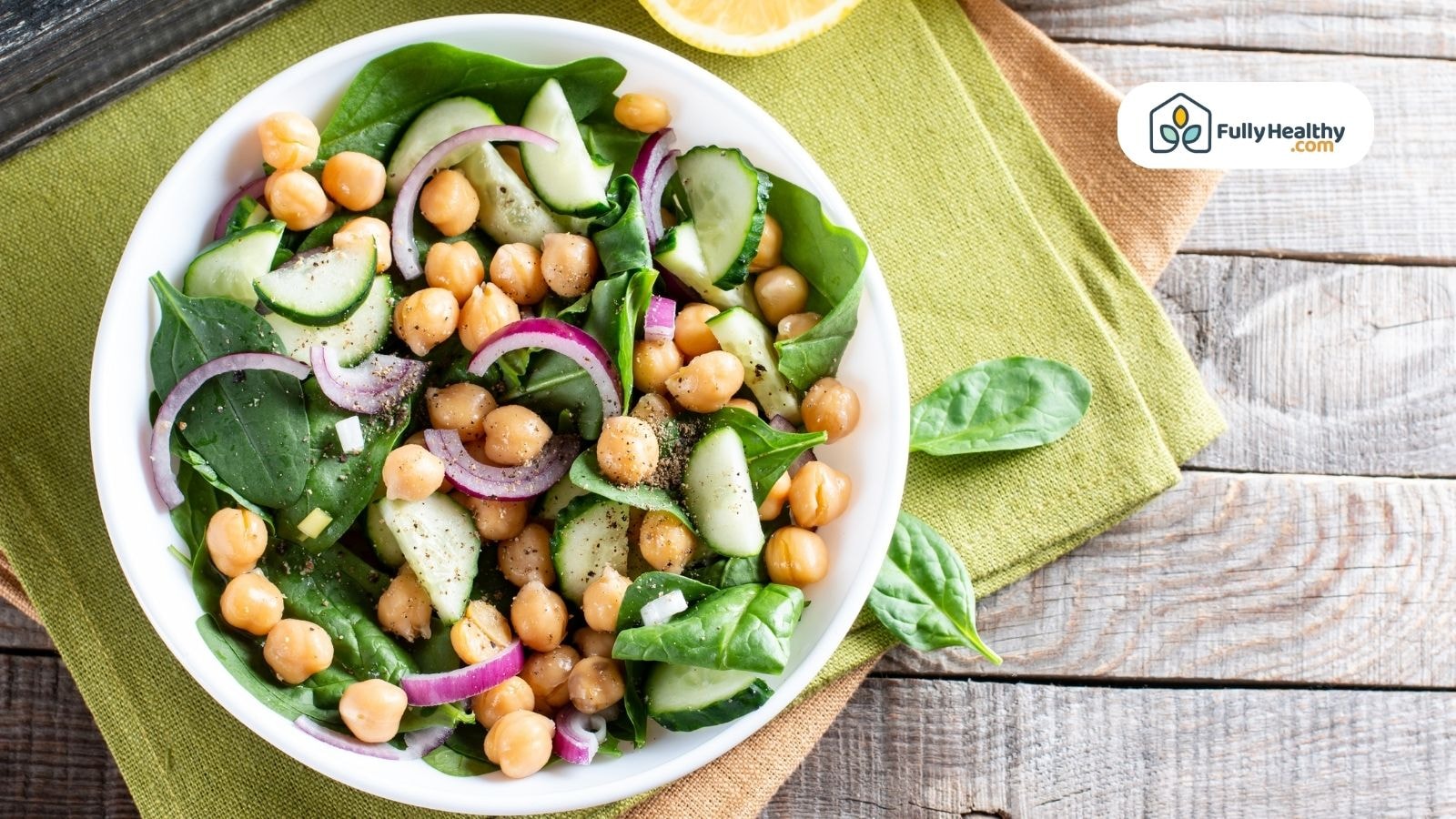 Fresh chickpea salad with cucumber spinach and red onion