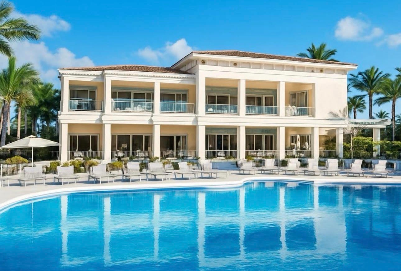 The image showcases a luxurious clubhouse surrounded by resort-style amenities, including well-maintained tennis courts and a junior Olympic-sized swimming pool, all set within the Gulf Harbour Yacht and Country Club in Fort Myers, Florida. This vibrant community offers world-class amenities and recreational activities, perfect for those seeking an active lifestyle in Southwest Florida.
