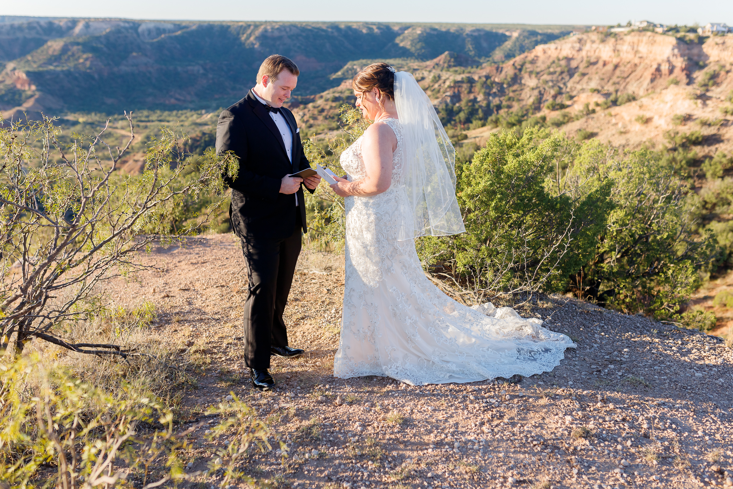 Couple exchanging vows near the canyon at the elopement ceremony in Texas.