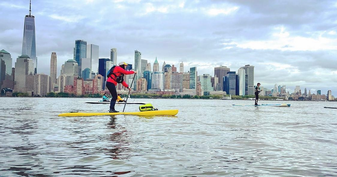 stand up paddle boards with new york city in the background