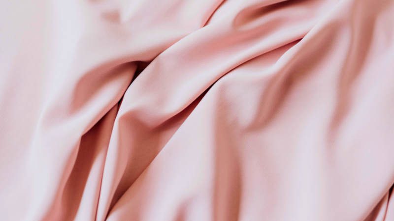 A close up shot of a pink cupro fabric