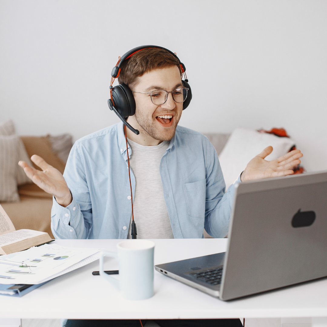 man at his laptop with headphones on communicating with someone