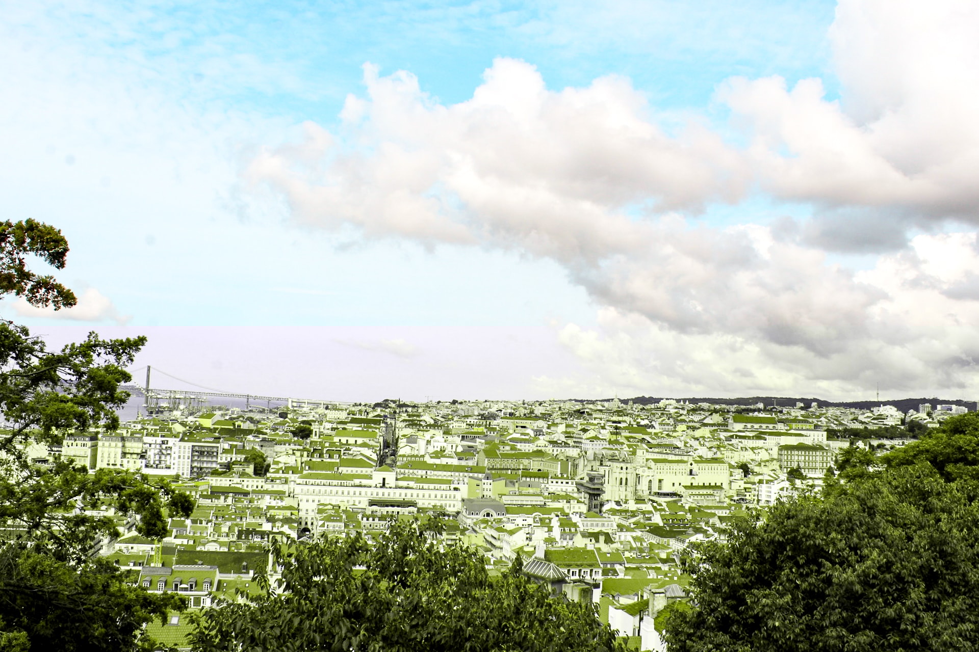 Where to stay in Lisbon Buildings in Lisbon with the red-roofs and a view of the bridge