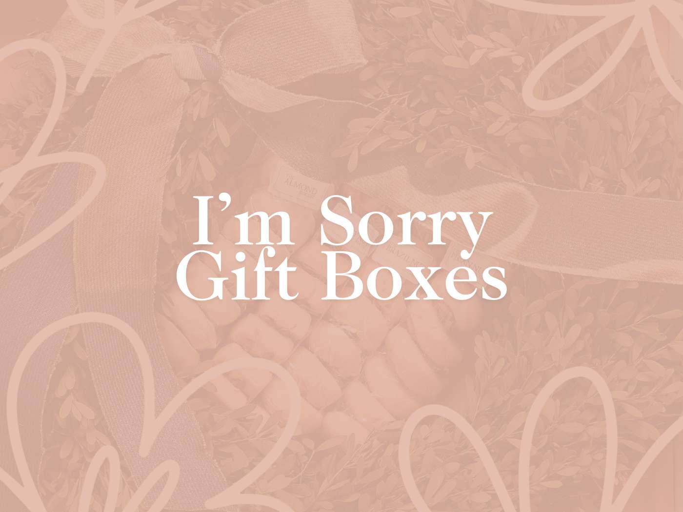 Elegant gift box tied with a pink ribbon, nestled among soft floral accents, representing a heartfelt gesture of apology. Part of the I'm Sorry Gift Boxes Apology Gifts Collection from Fabulous Flowers and Gifts.
