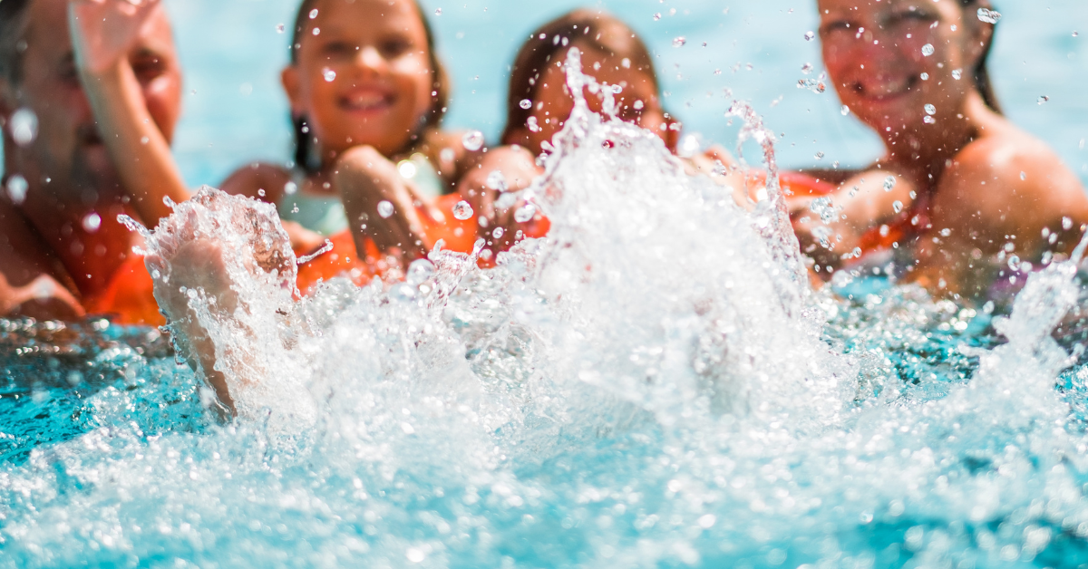 Family enjoying a summer day splashing in a swimming pool at a North Wildwood vacation rental.
