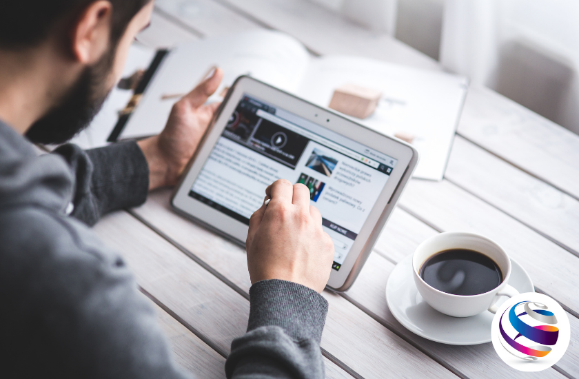 Guy googling on tablet in How To Become a Web Designer Without a Degree