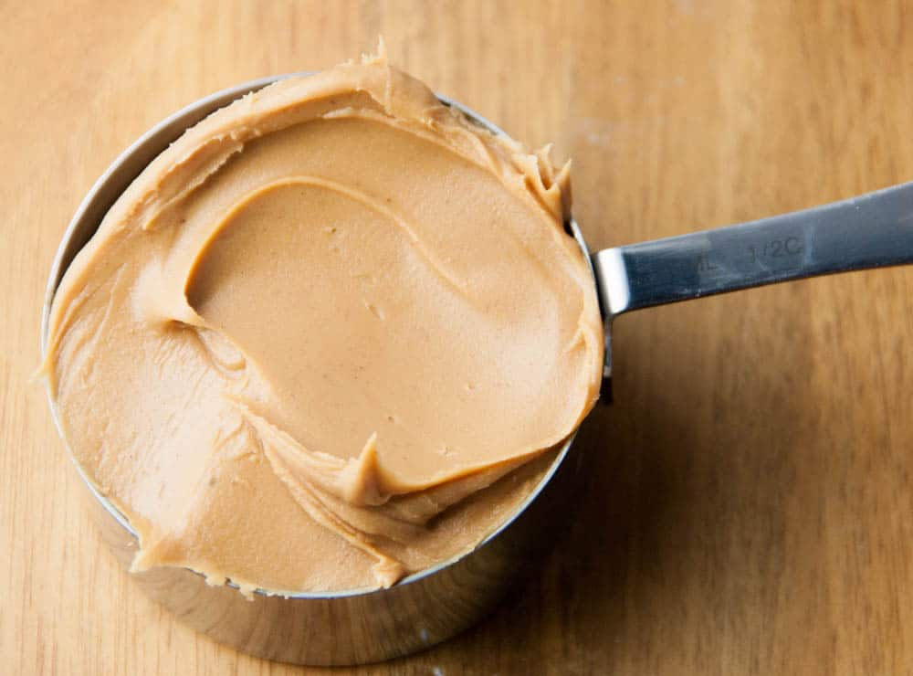 a measuring cup of peanut butter