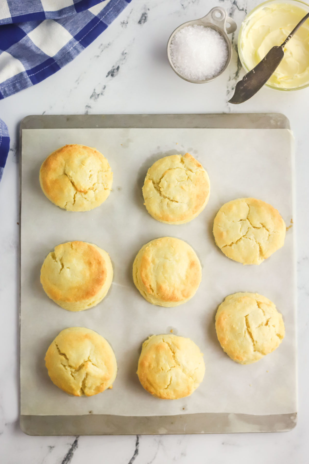 baked biscuits on a parchment lined baking sheet