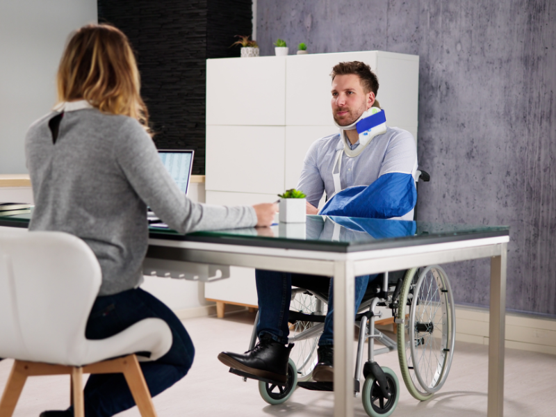 Image of a person with car accident injuries working with a personal injury lawyer.