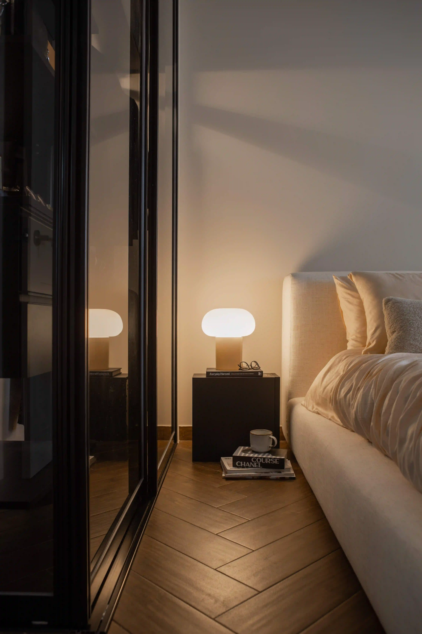 Cosy HDB bedroom at night, bedside lamp and herringbone floor synced to smart switches for mood lighting