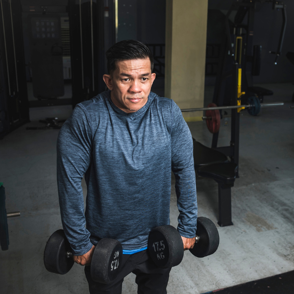 Image showing a person performing shrugs with dumbbells.