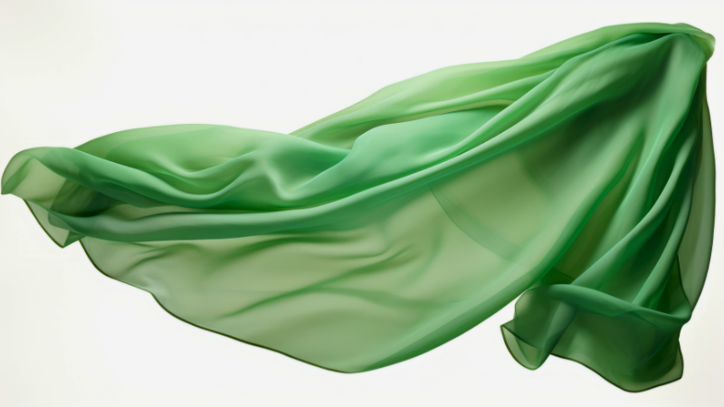 A close up image of a green chiffon fabric