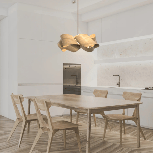 Modern dining area with a wooden table and chairs, illuminated by a sculptural pendant light made of curved wooden panels, set against a minimalist white kitchen backdrop.