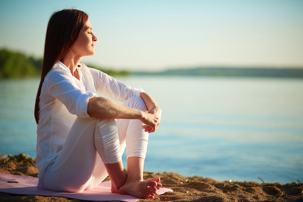 A woman meditating in nature https://medium.com/spiritual-secrets/4-major-signs-youre-having-a-spiritual-awakening-7f7caae59ad2 