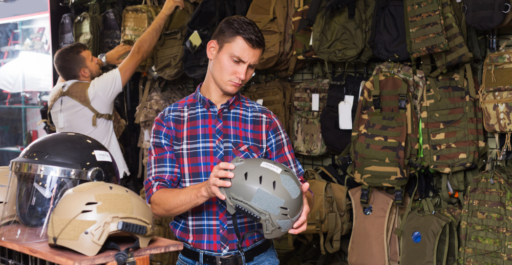 Man checking a ballistic helmet in a body armor shop