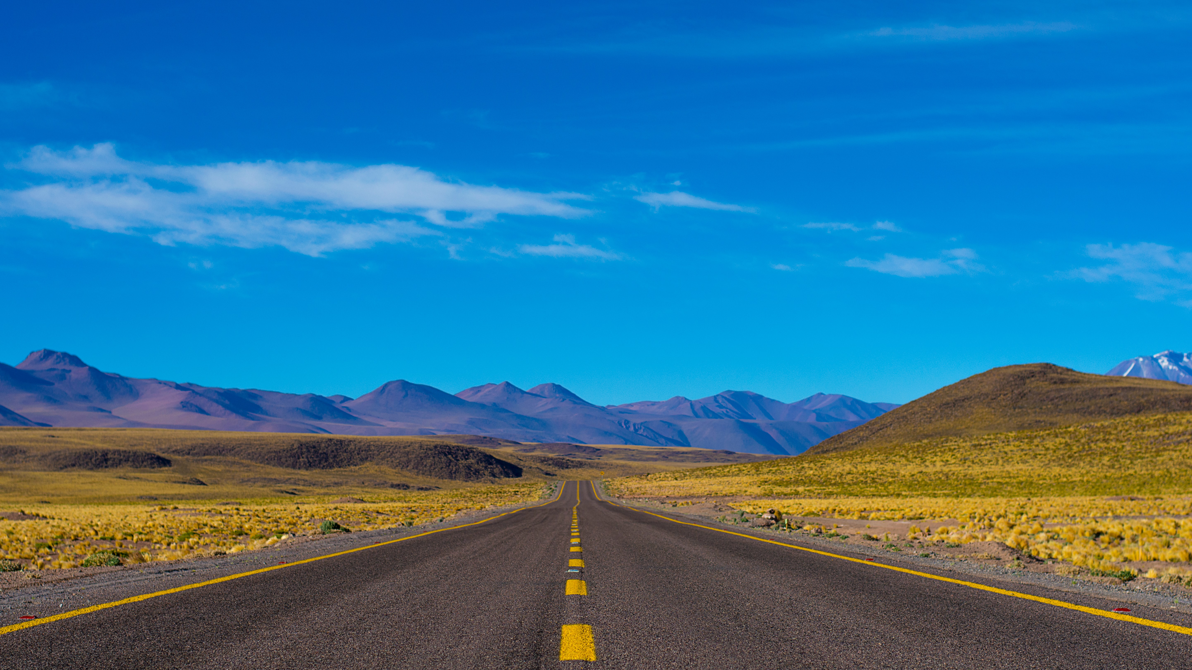 A view of an empty wide open country road from the center of the highway. Great car shipping companies will verify the size of your vehicle and the distance you need the car shipped.