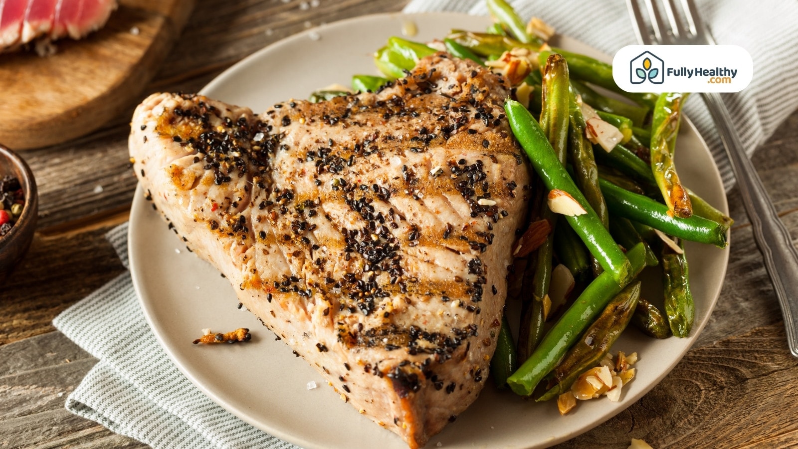 Grilled tuna steak with black pepper and green beans on plate