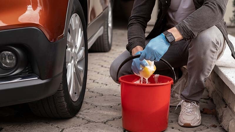 Red bucket with a soapy sponge