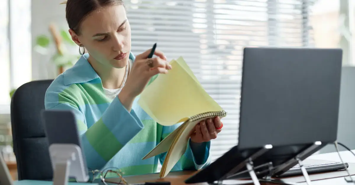 Woman reviewing cash vs accrual accounting records for creator income and tax planning.