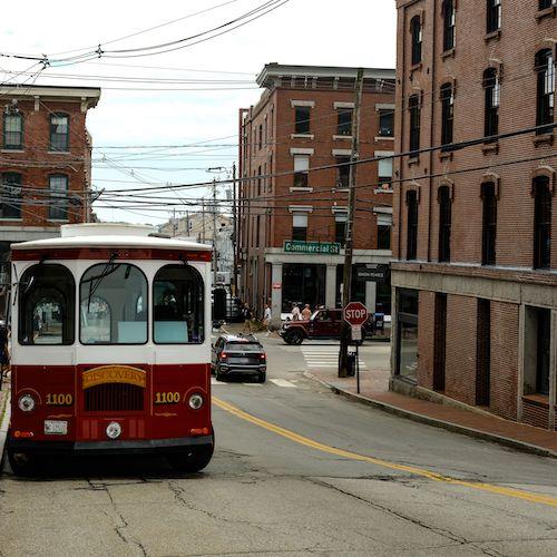 Red trolley amidst the brick buildings of downtown Portland