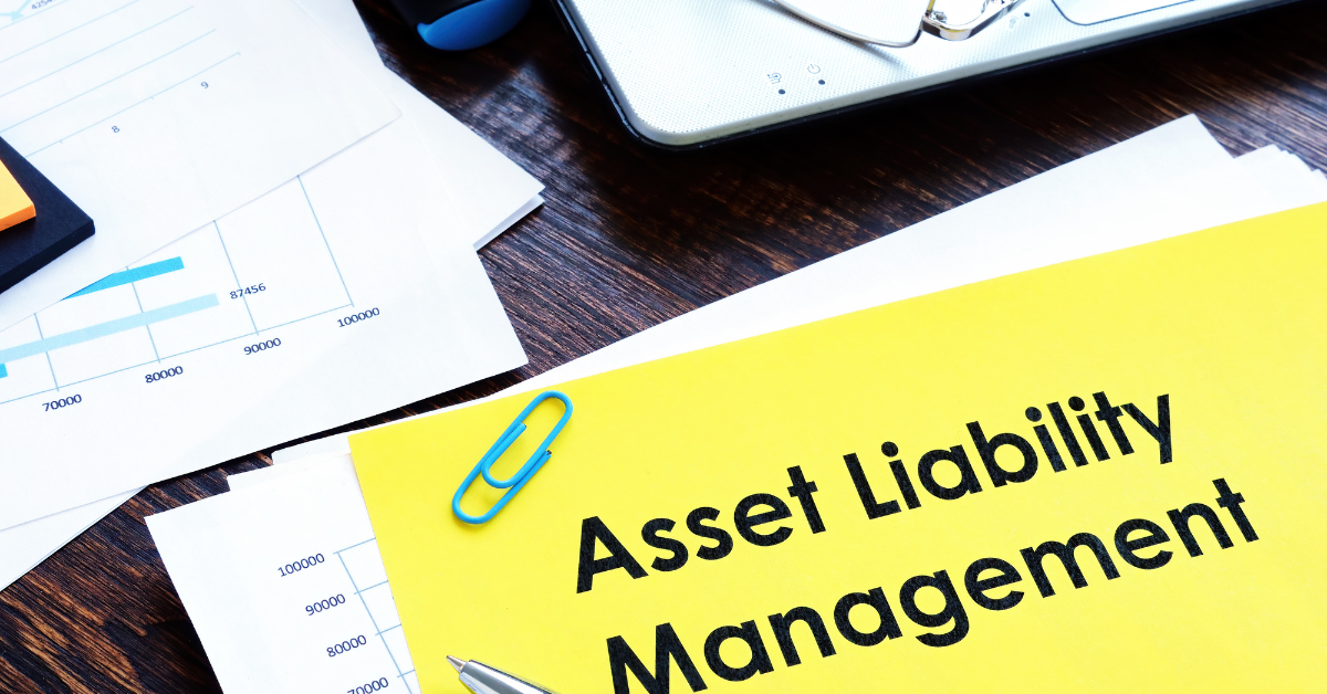 Document labeled Asset Liability Management with financial charts and papers, representing what is asset liability management in personal and business finance.