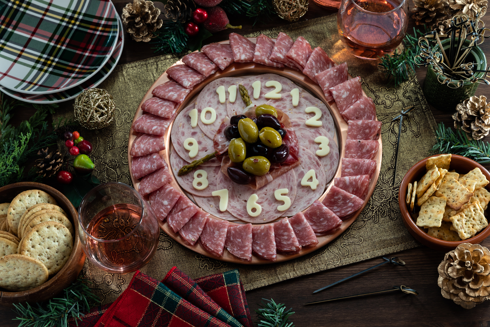 A charcuterie board with a variety of platters, layering techniques, and decorative touches