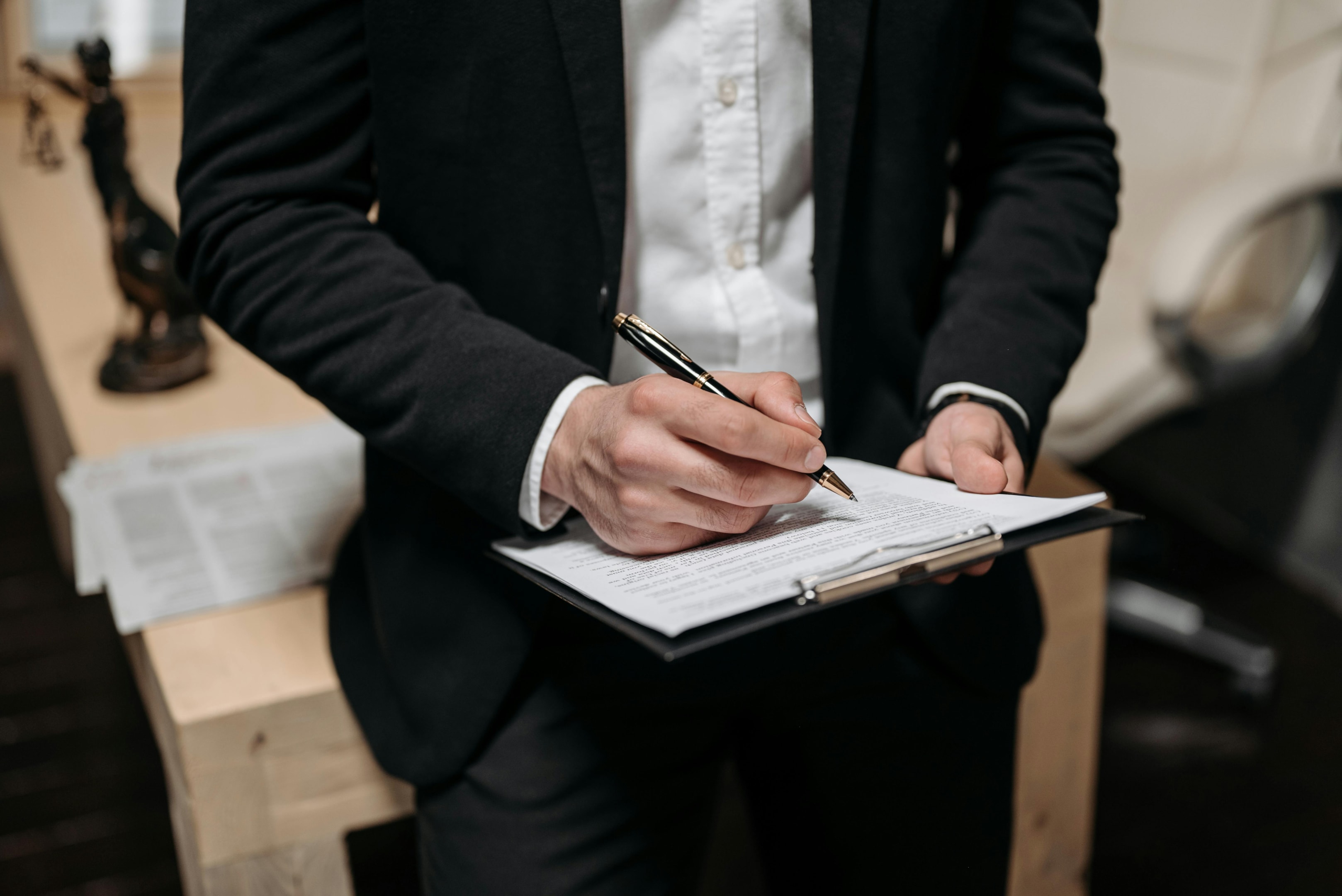 Real estate investor signs closing paperwork on a new property.