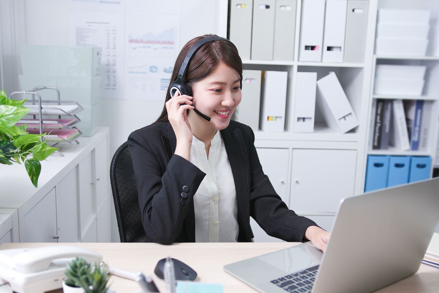 A remote employee talking on headset.