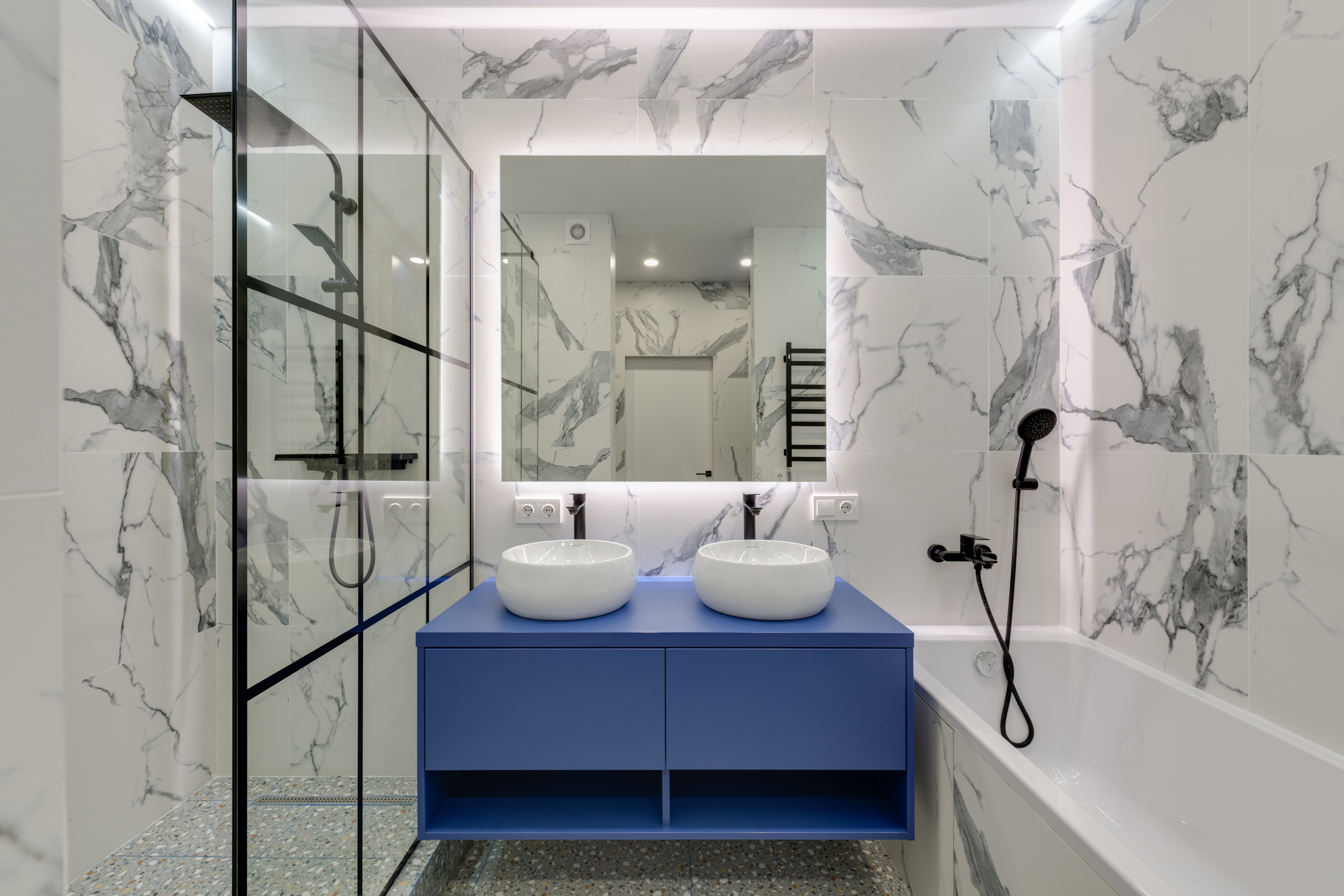 blue double vanity sink in white marble bathroom