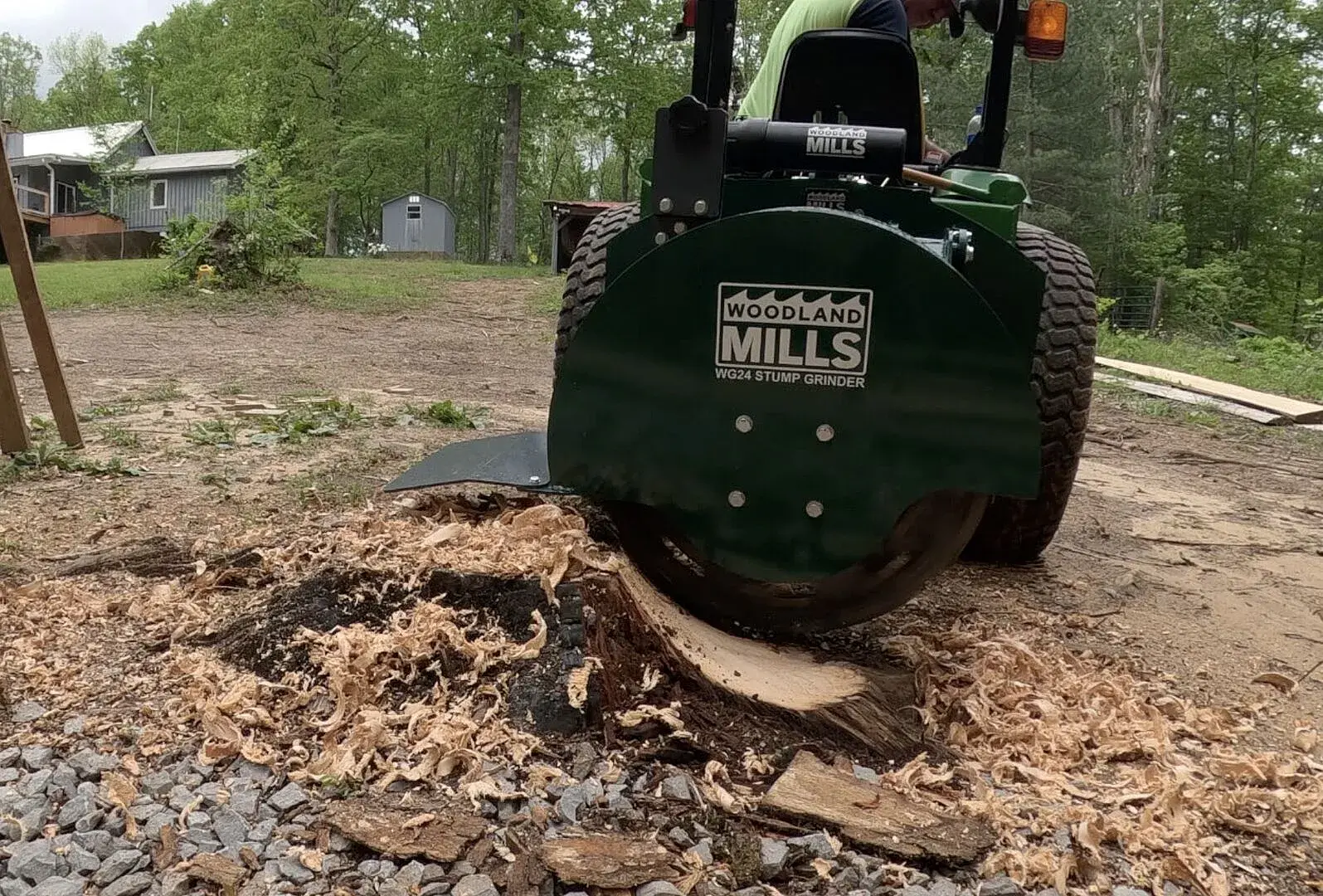 A Woodland Mills WG24 Stump Grinder cleaning up a stump.