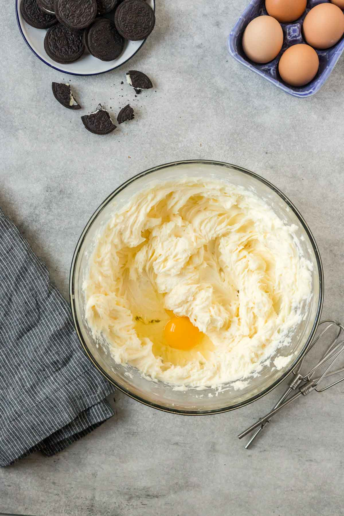 egg added to cheesecake mixture in bowl