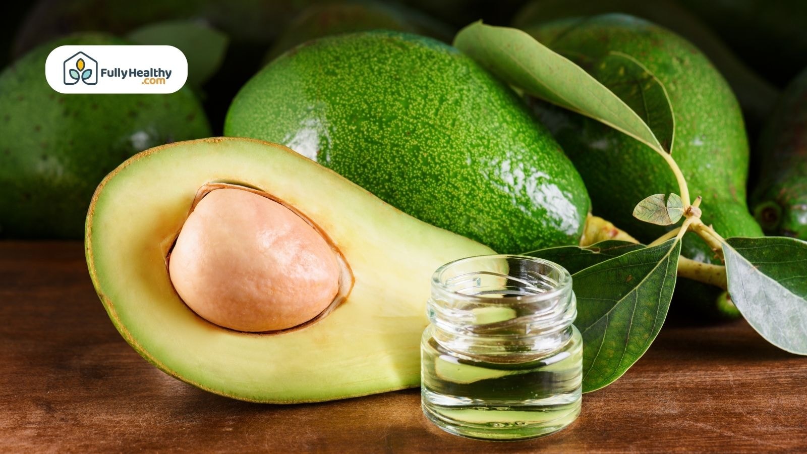 Halved avocado with small jar of pure avocado oil