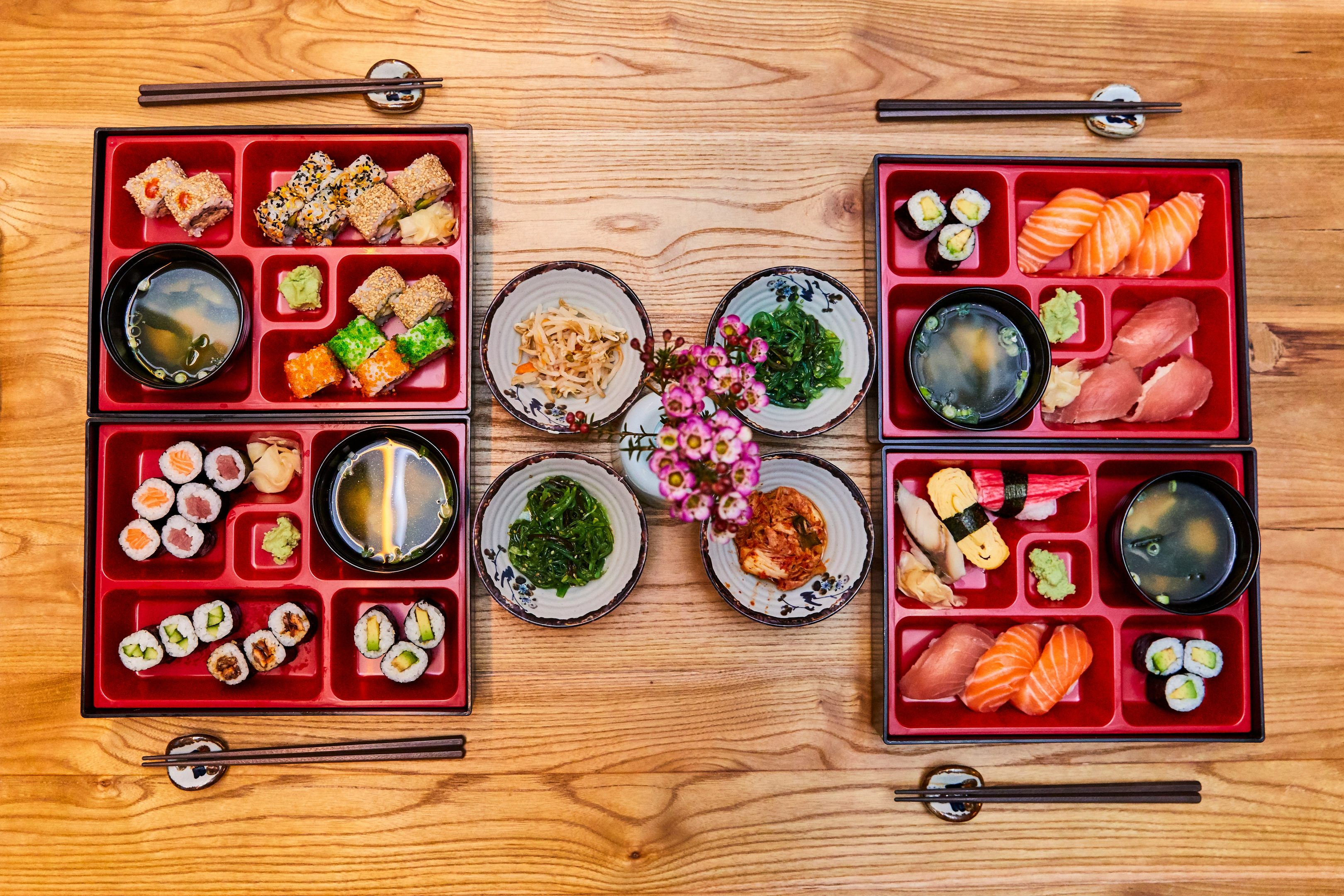 Image from the top of asian food in bento boxes to illustrate the bento grid design concept inspiration