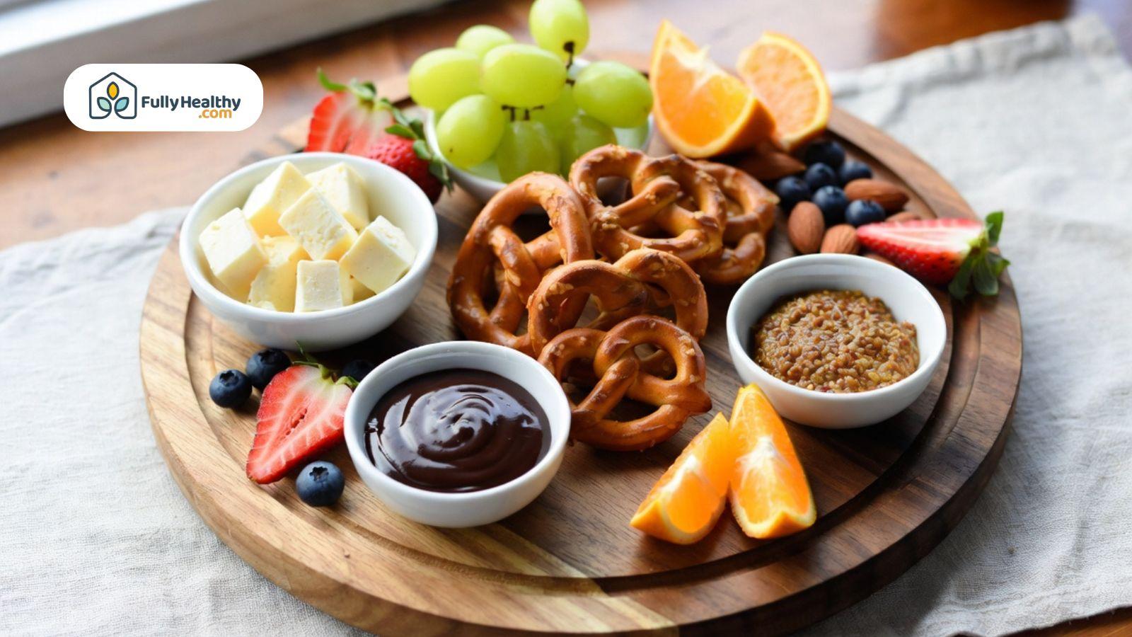 Soft pretzels served with fruit, cheese, mustard, and chocolate dipping sauces.
