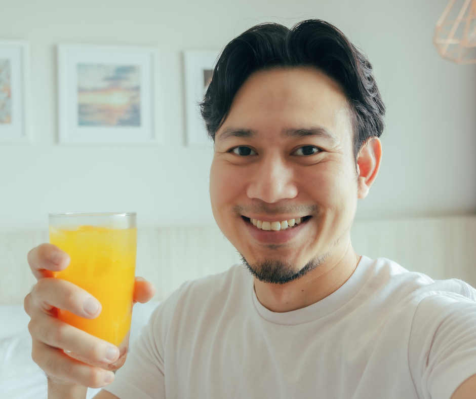                                      A person celebrating 6 months of sobriety with a glass of orange juice