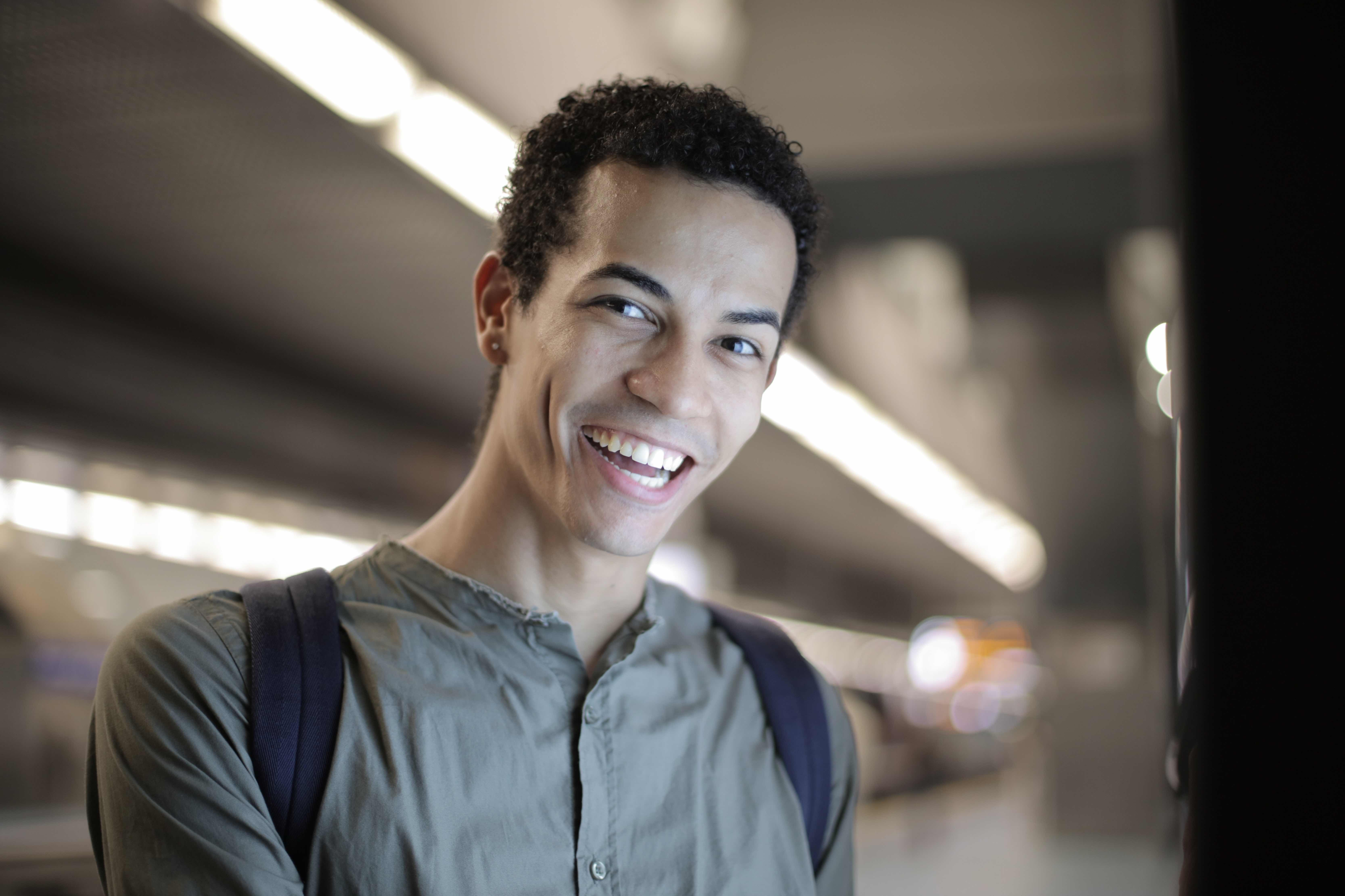 A male smiling showing clean teaath with colored composite fillings