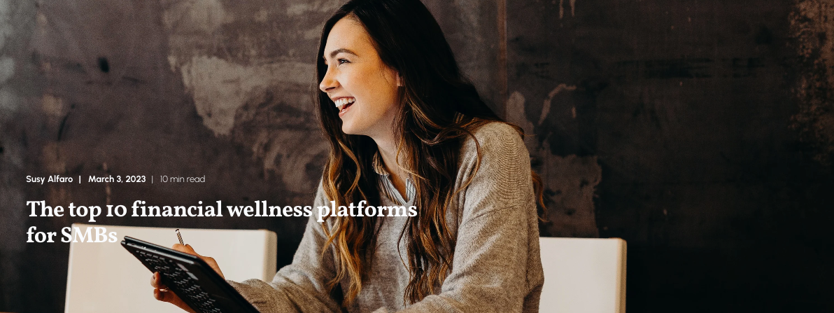 A woman looks off-camera whilst holding an ipan in her hand. The title reads: The top 10 financial wellness platforms for SMBs.