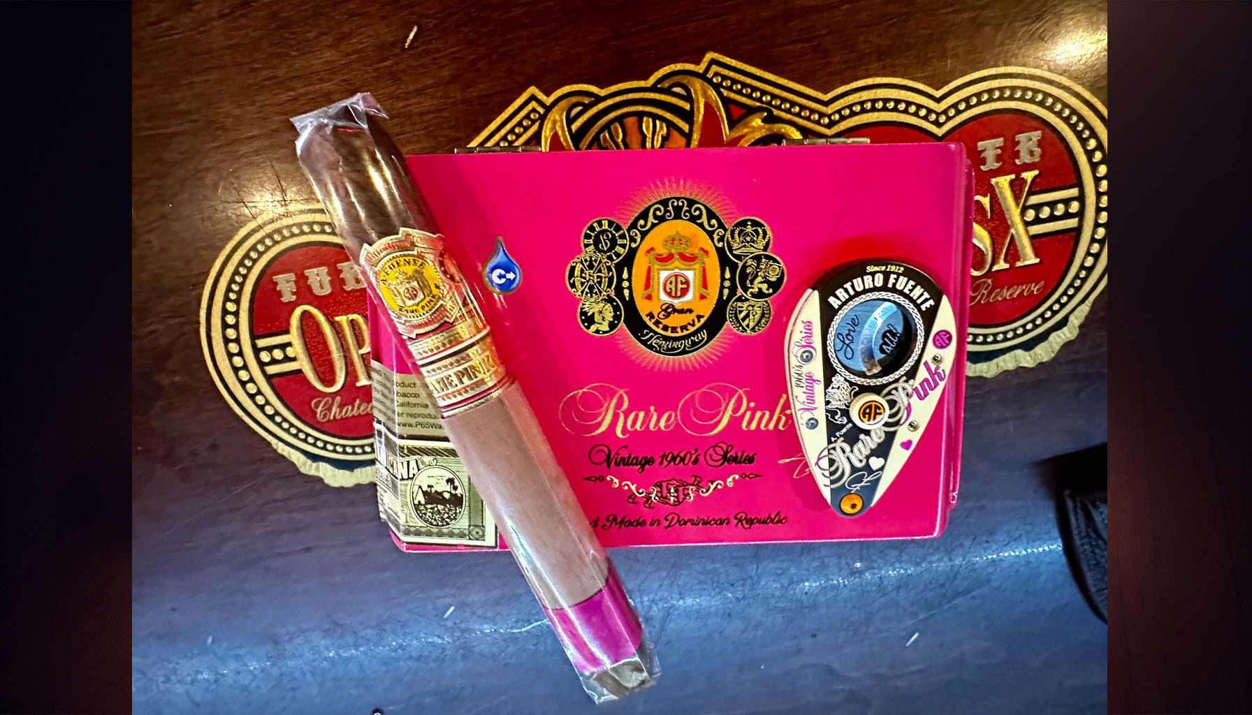 Illustration of a luxurious cigar box with a pink ribbon tied around it