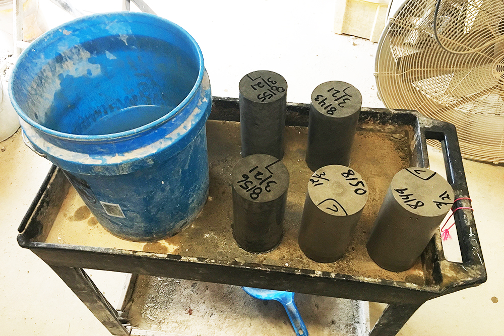Concrete test cylinders being prepared in a laboratory