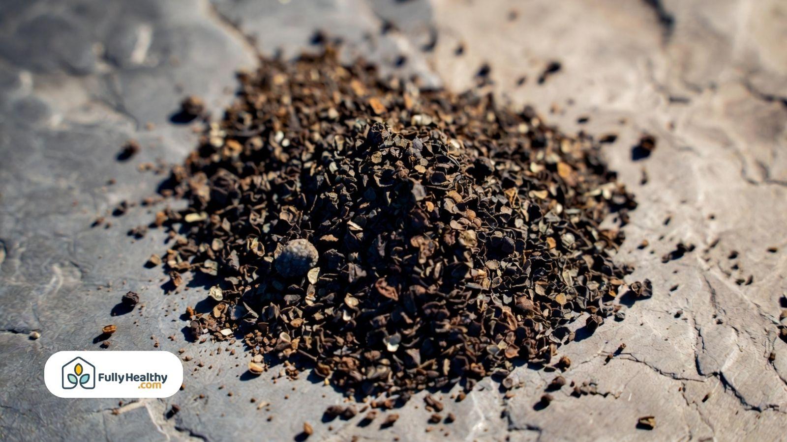 Close-up of ground black pepper on a surface.