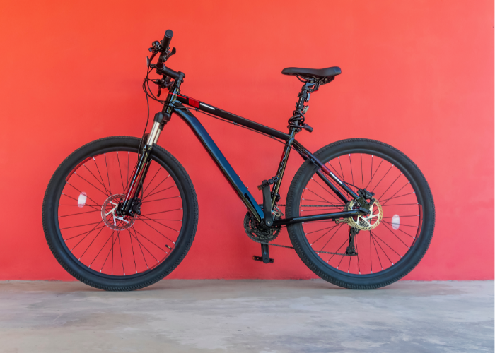 A mountain biker riding an aluminum frame mountain bike