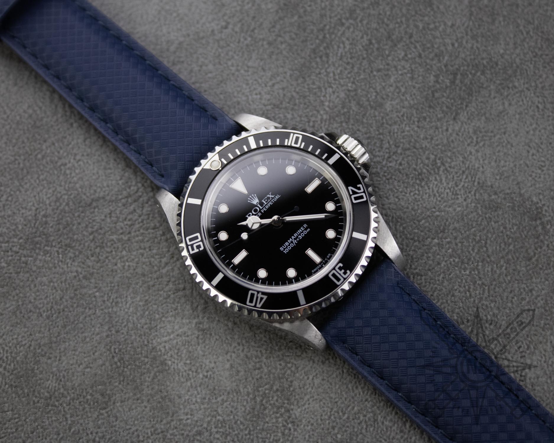 Rolex Submariner on a navy blue rubber watch strap