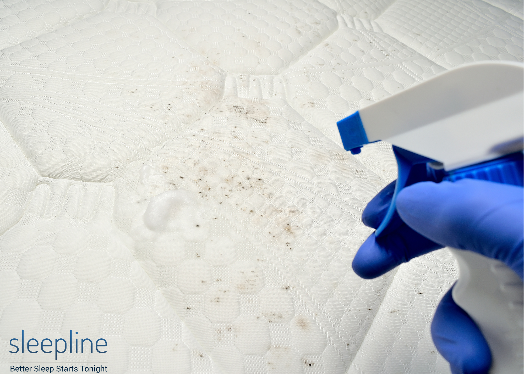 Person using a rubbing alcohol spray on a mattress