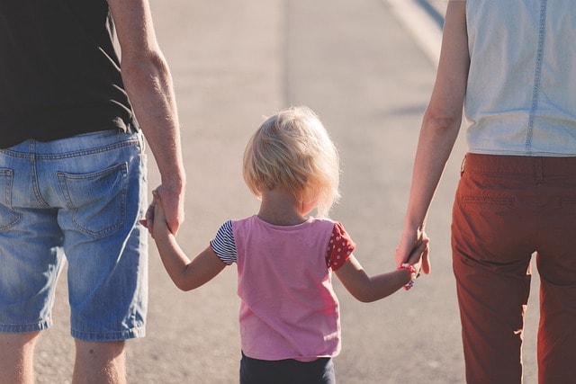 family, holding hands, parents of younger children with joint custody shown in a pic