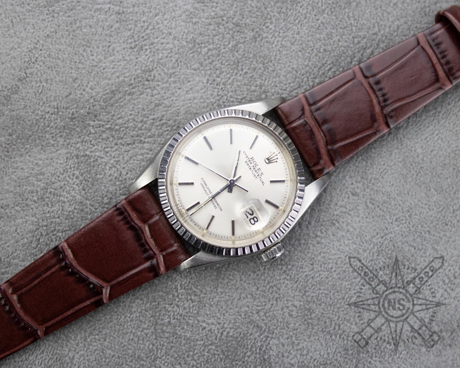 A stylish alligator watch strap displayed on a luxury timepiece.