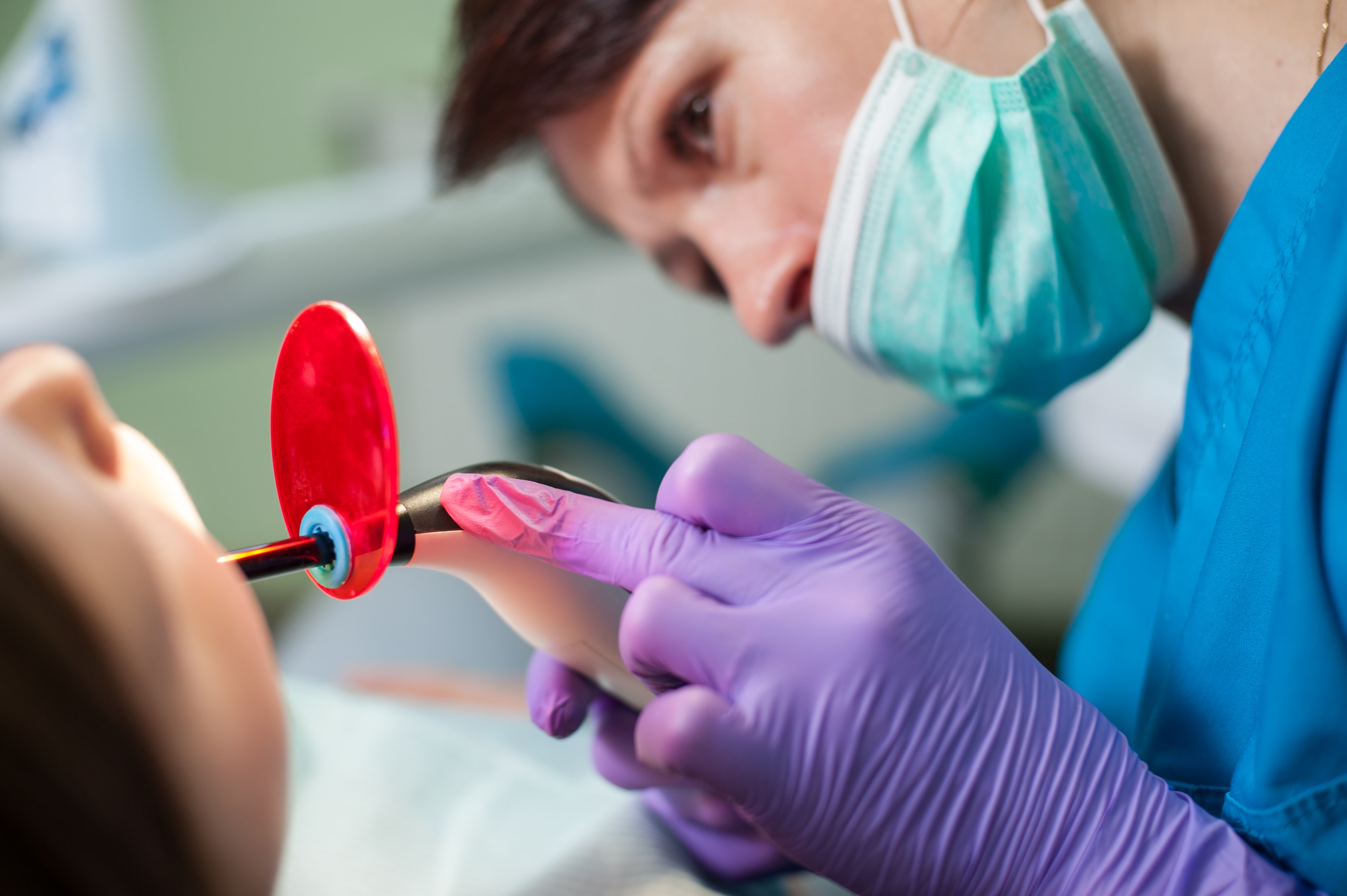 A photo of an oral surgeon bonding a tooth