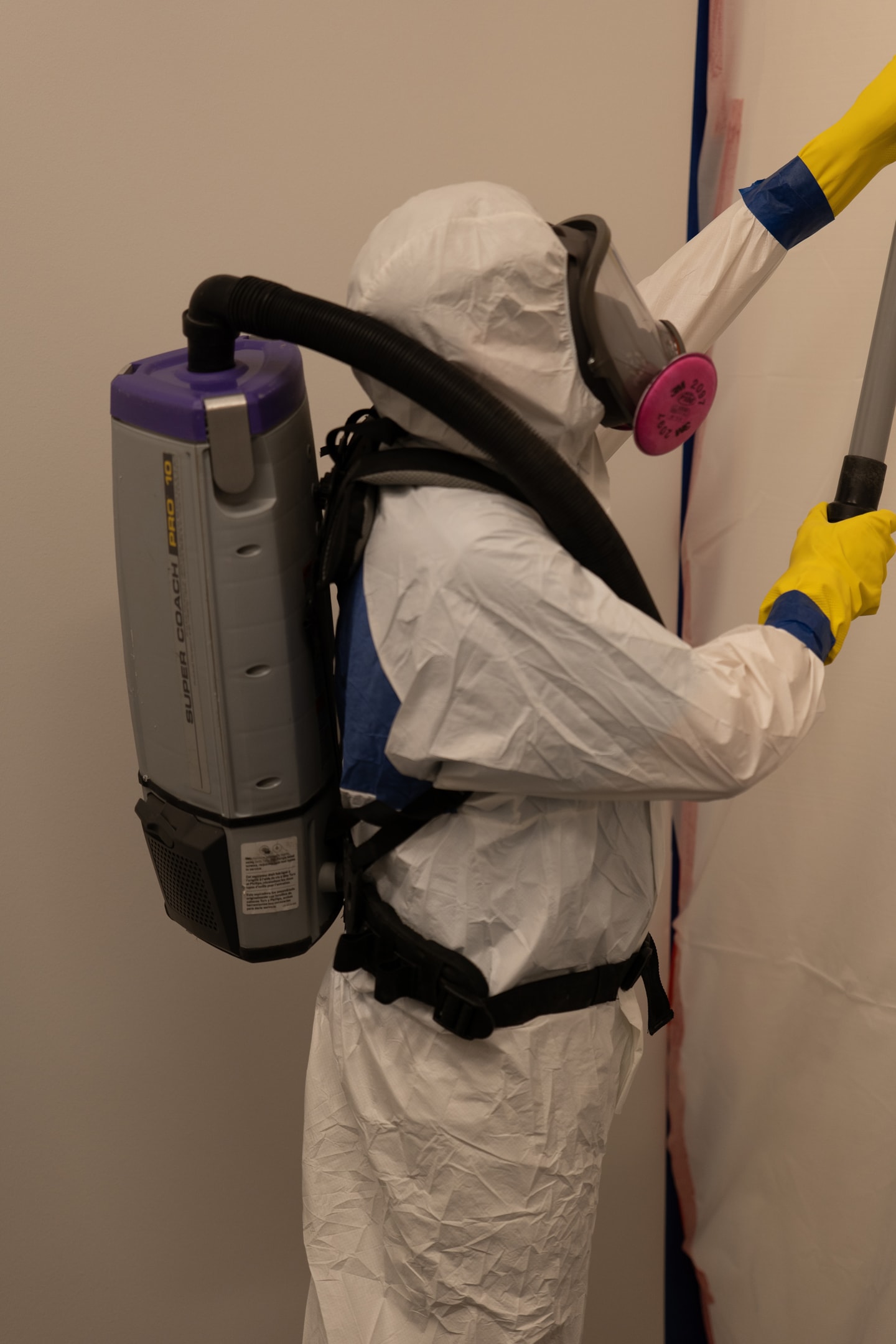 A technician using a portable HEPA vacuum cleaning.