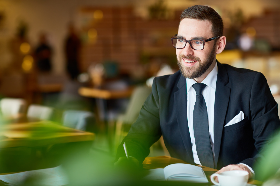 Smiling business professional during a meeting, symbolizing a consultation with a business broker